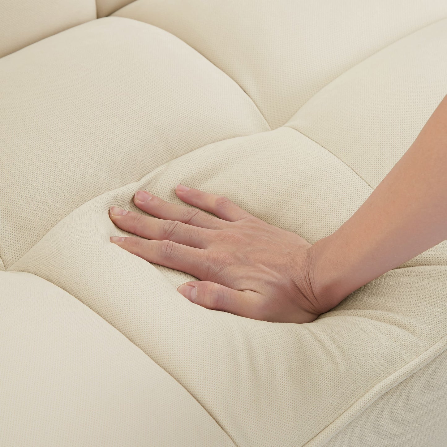 Close-up of soft fabric on beige sofa with wooden legs showcasing plush cushioning and comfort