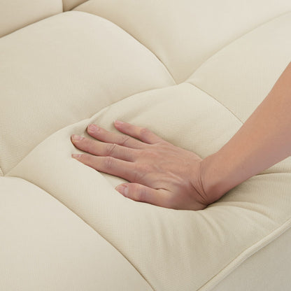 Close-up of soft fabric on beige sofa with wooden legs showcasing plush cushioning and comfort